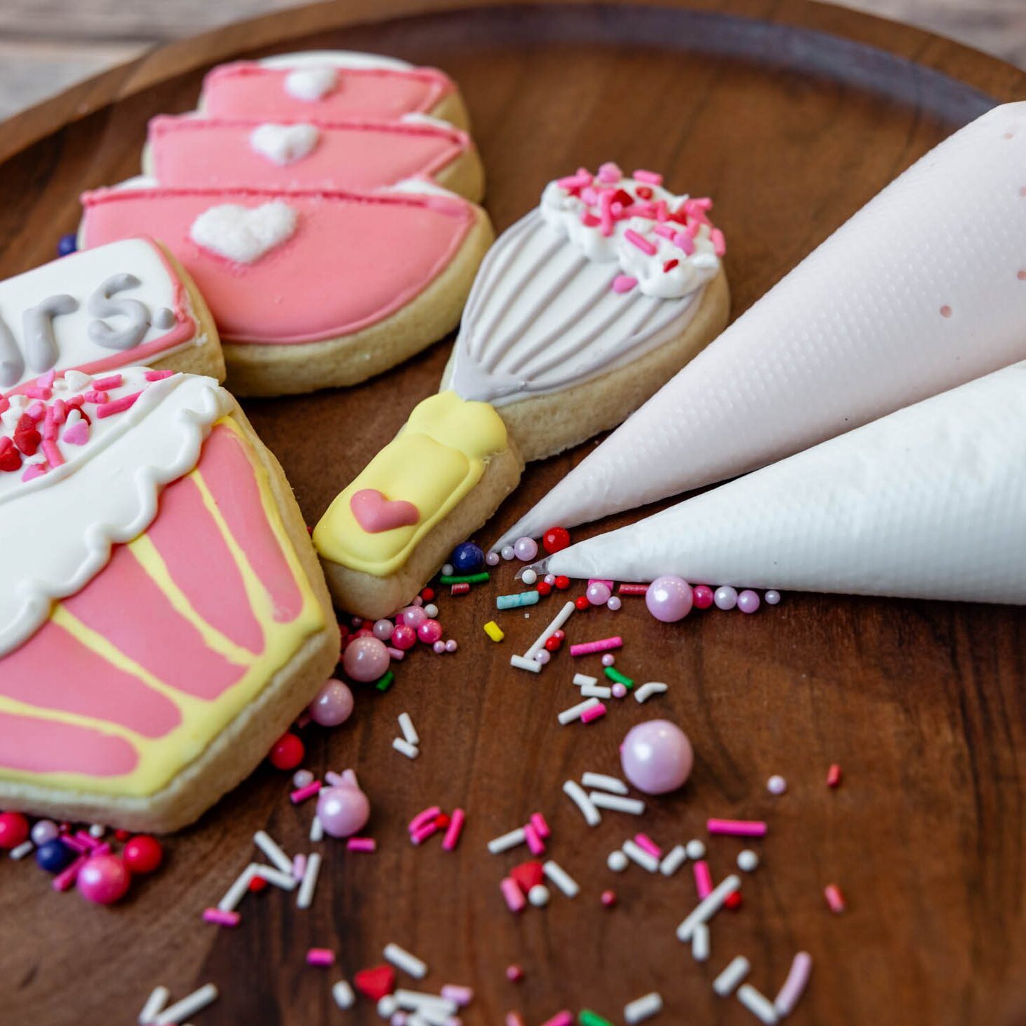 Pink heart and cupcake cookies with piping bags